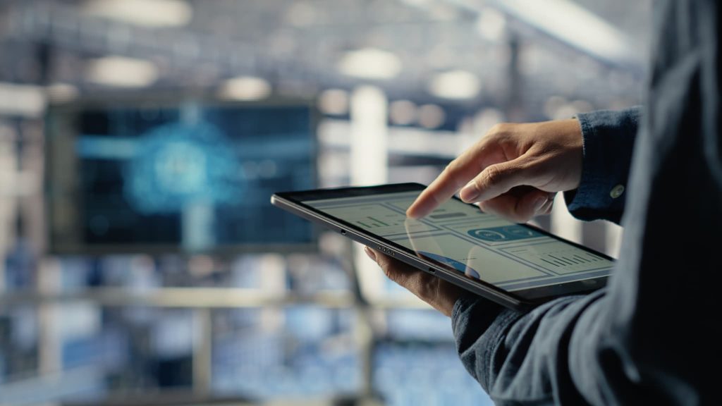 タブレット端末に表示されたグラフやデータを指で操作する手元。オンライン完結型のファクタリングサービスを利用して、効率的に資金調達の状況を確認する場面