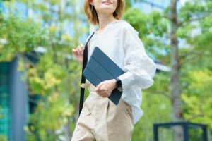 フリーランスの始め方を解説する記事のメイン画像。タブレットを持って屋外を歩く女性の姿で、時間や場所に縛られない自由な働き方を表現